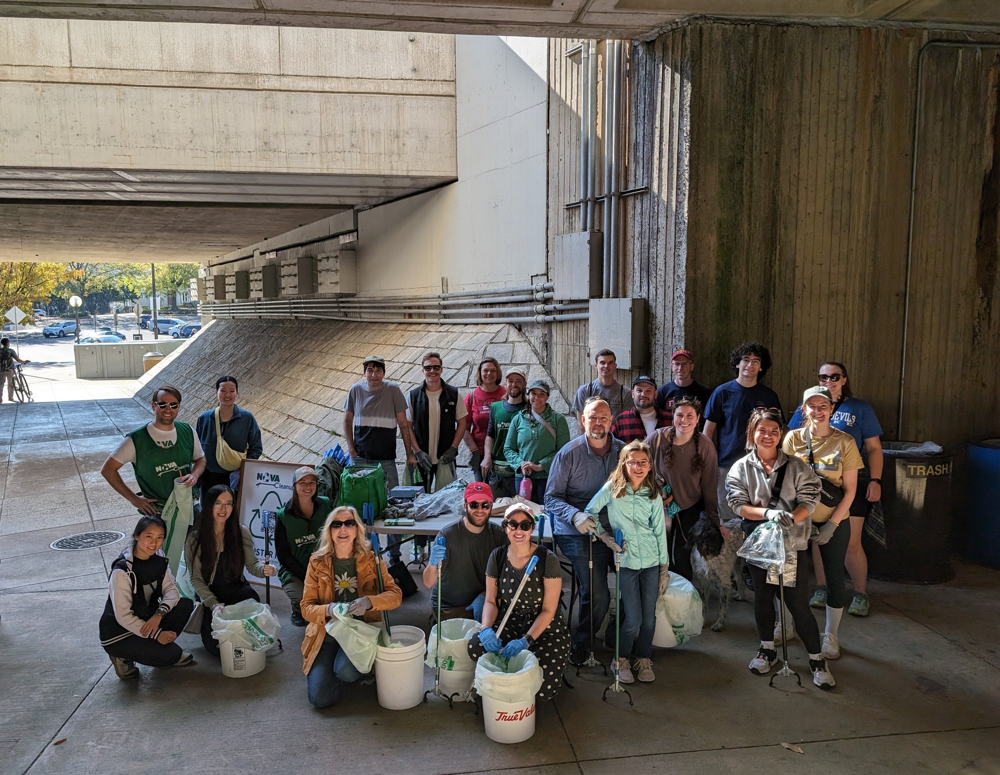 Volunteers under an overpass at East Falls Church metro stop ready to pick litter